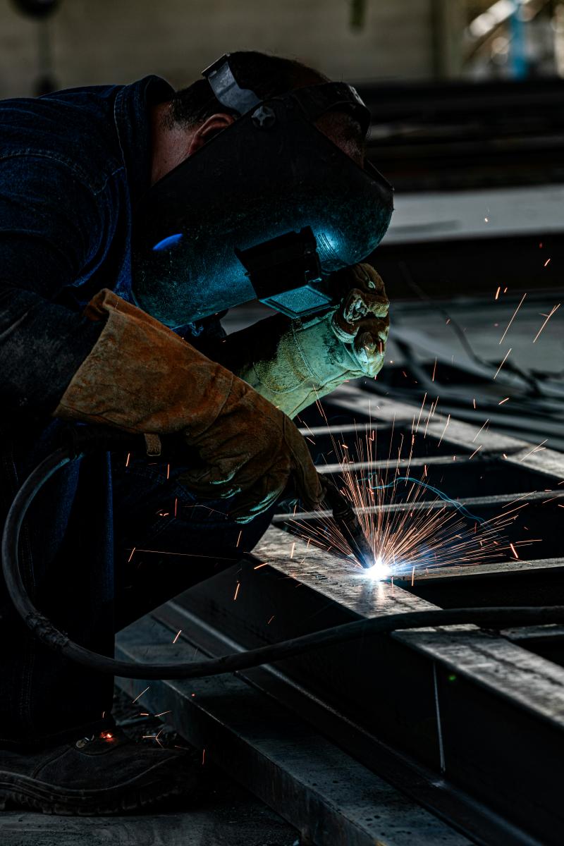 Welder welding on iron with mig machine