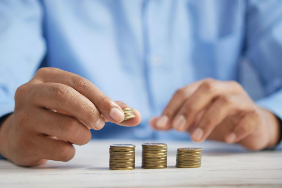 hands stacking a coin